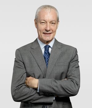 Cheerful senior businessman in a crossed arms gesture