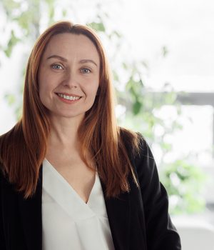 Indoors portrait of a business woman. Middle aged model female in a business office.